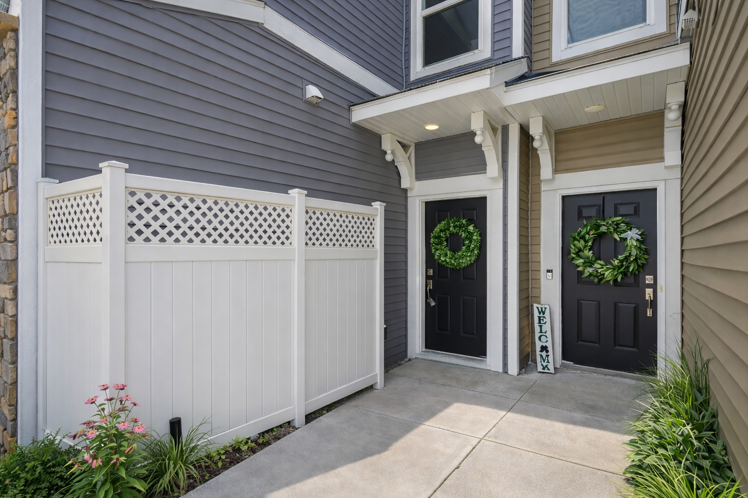 Door on the left virtually staged with privacy screening of the utilities