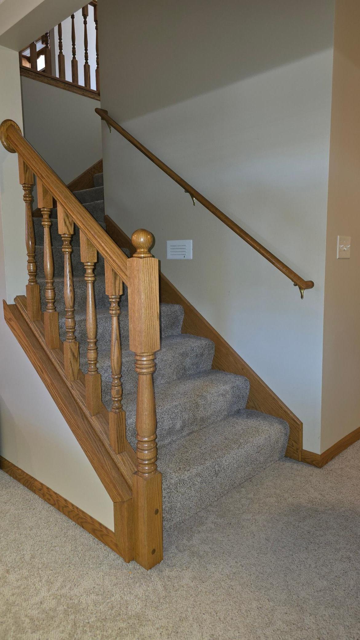 open staircase on the main floor leads to a nicely finished family room space with wet bar.jpg