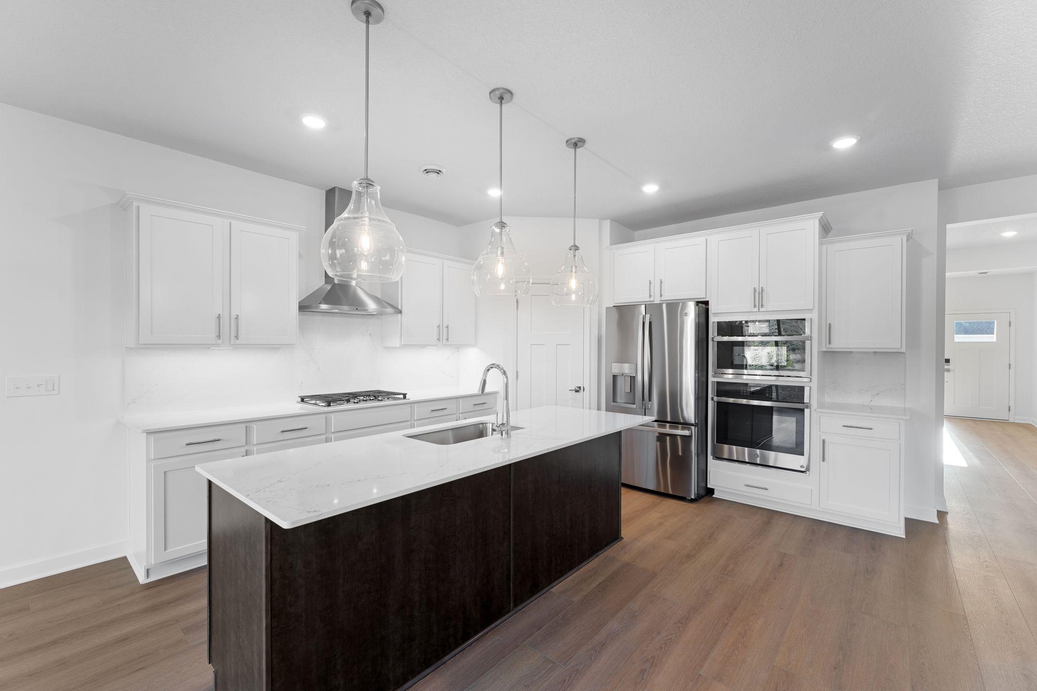 The kitchen features brand-new appliances, ample cabinetry, designer-selected countertops and a pantry for added storage space.