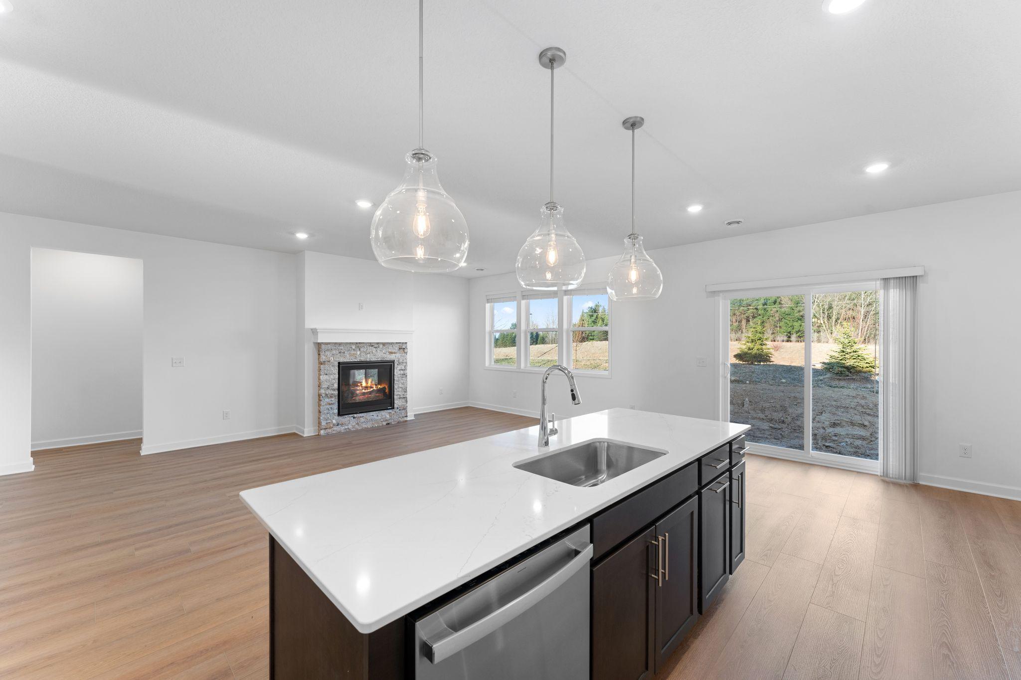 The kitchen overlooks the dining room and great room in this open concept floorplan
