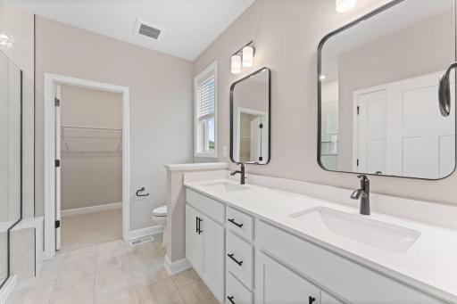 The en-suite bathroom features a glass-enclosed shower convenient double sinks