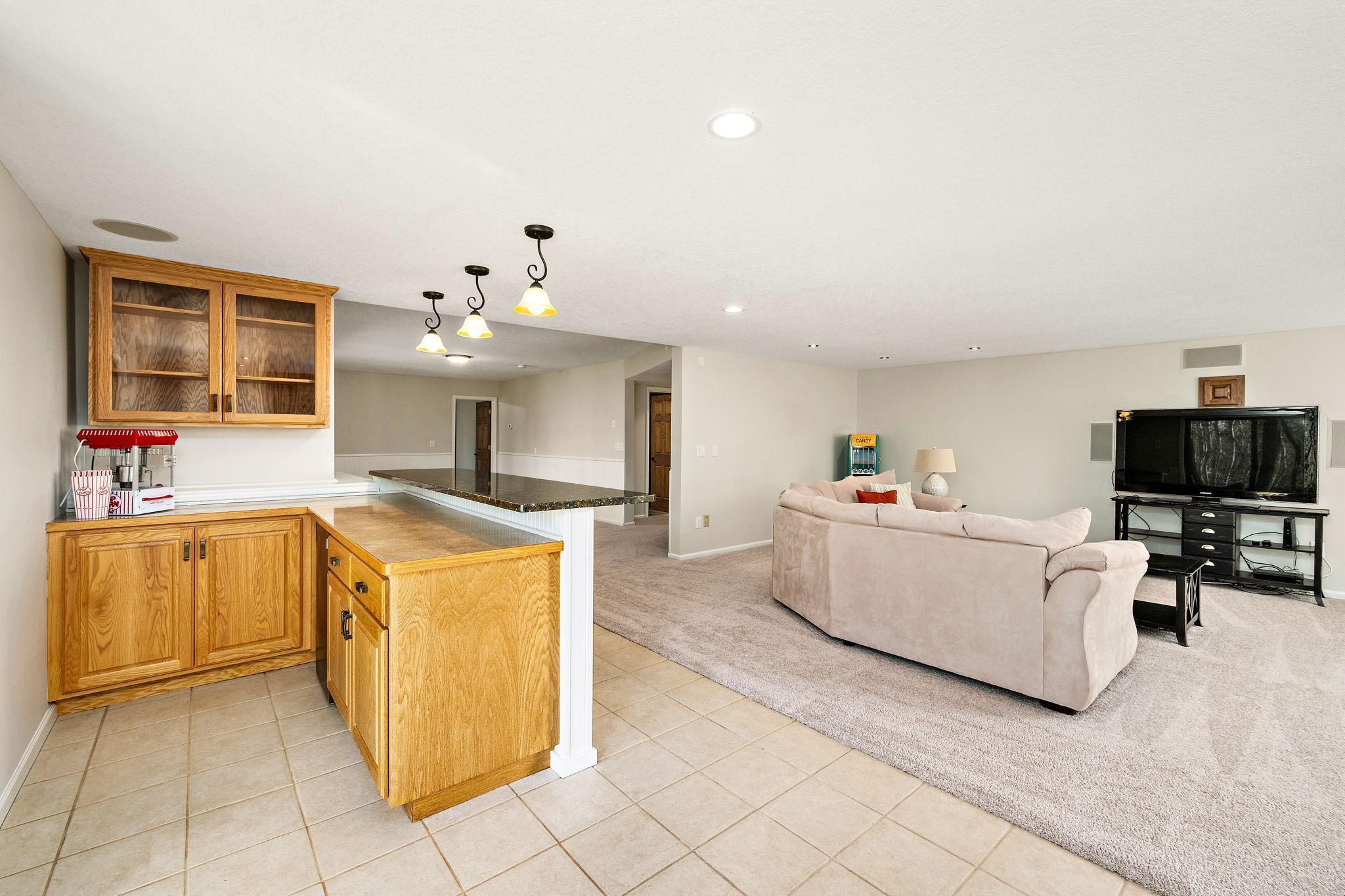 Basement family room bar with built-in cabinets