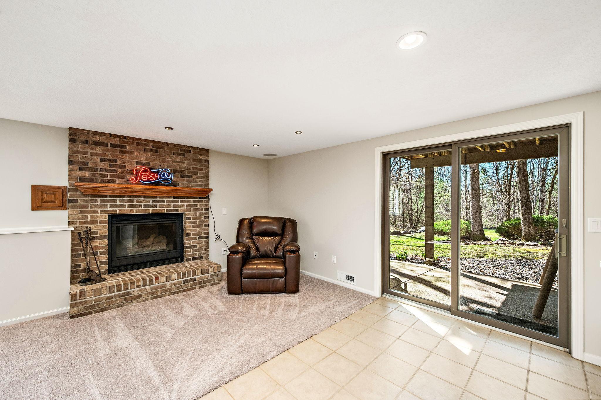 Basement family room with a gas fireplace and walkout