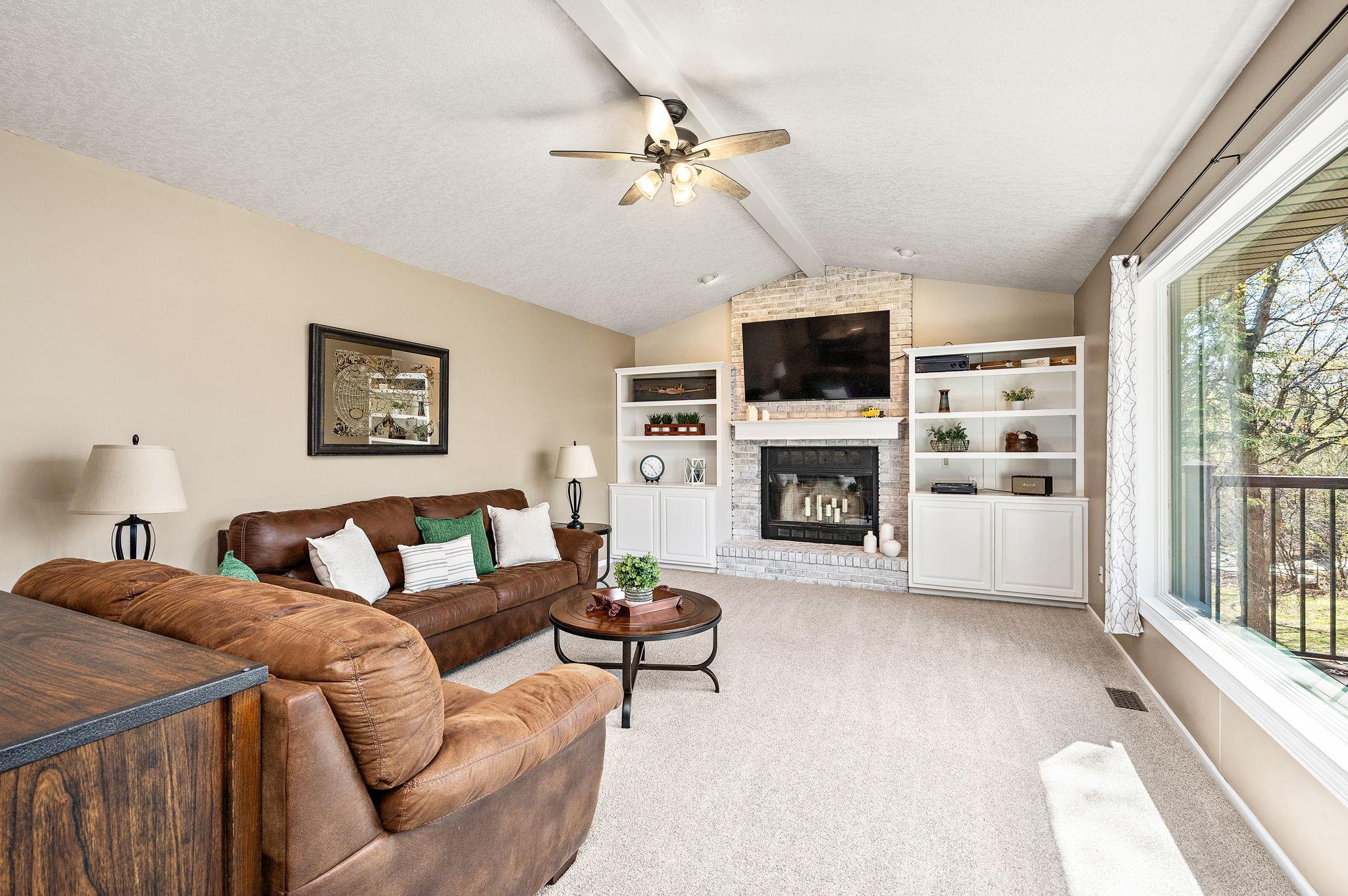 Main floor family room with a wood burning fireplace and built-ins