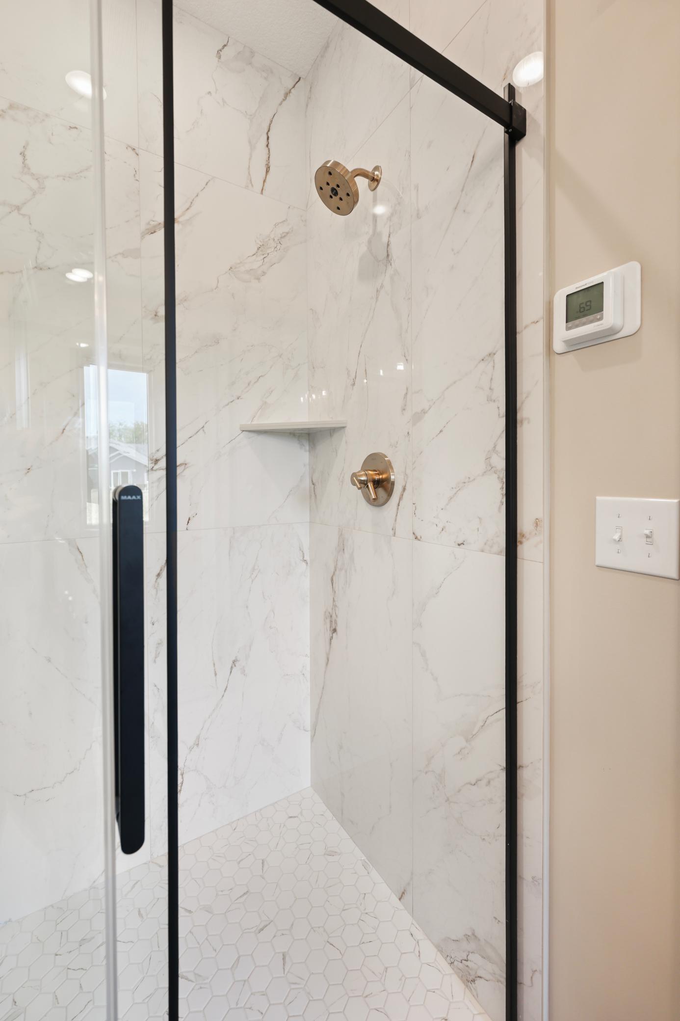 Walk in shower in primary with beautiful tile