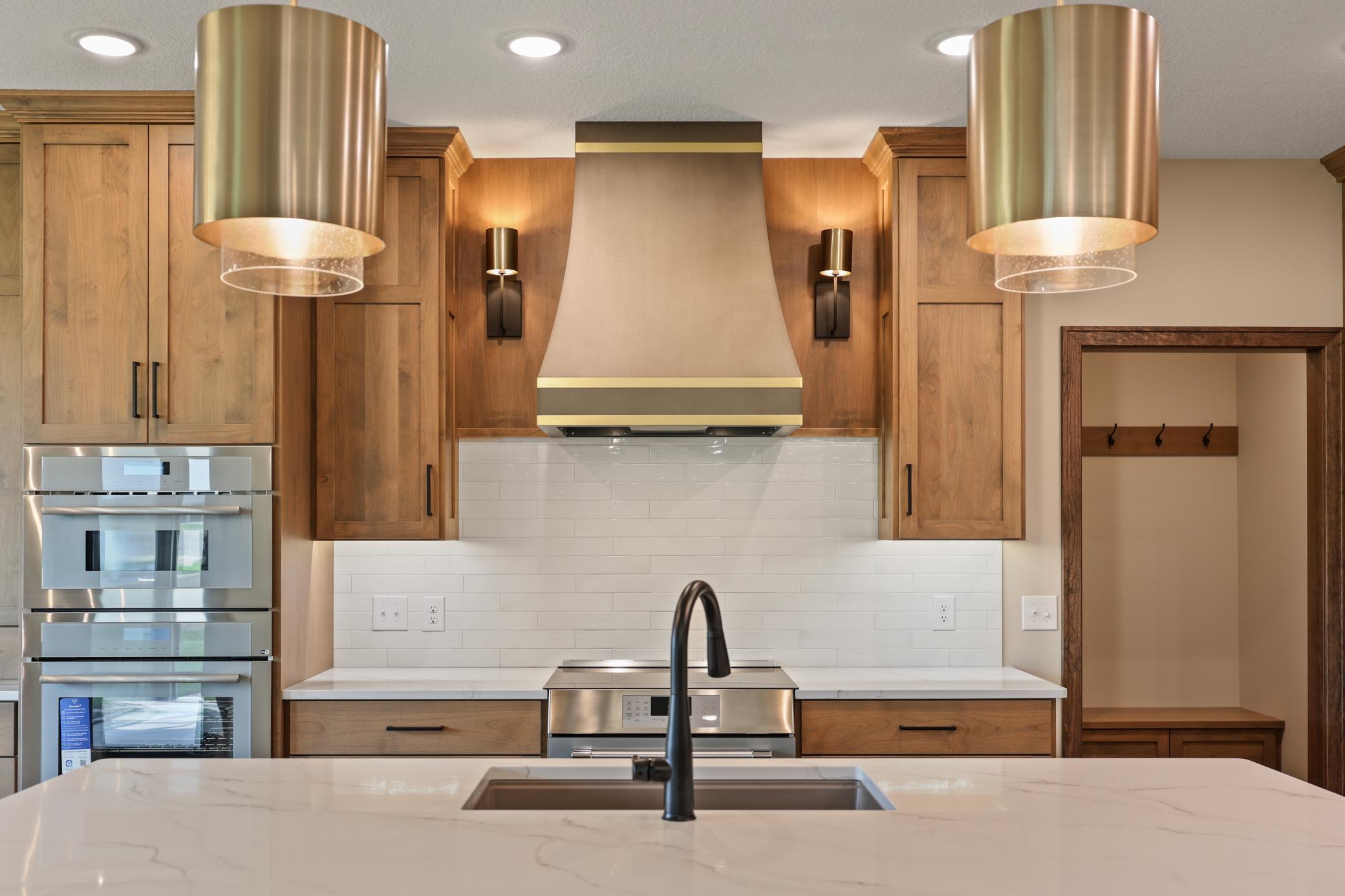 The range hood with side sconces offer a touch of class