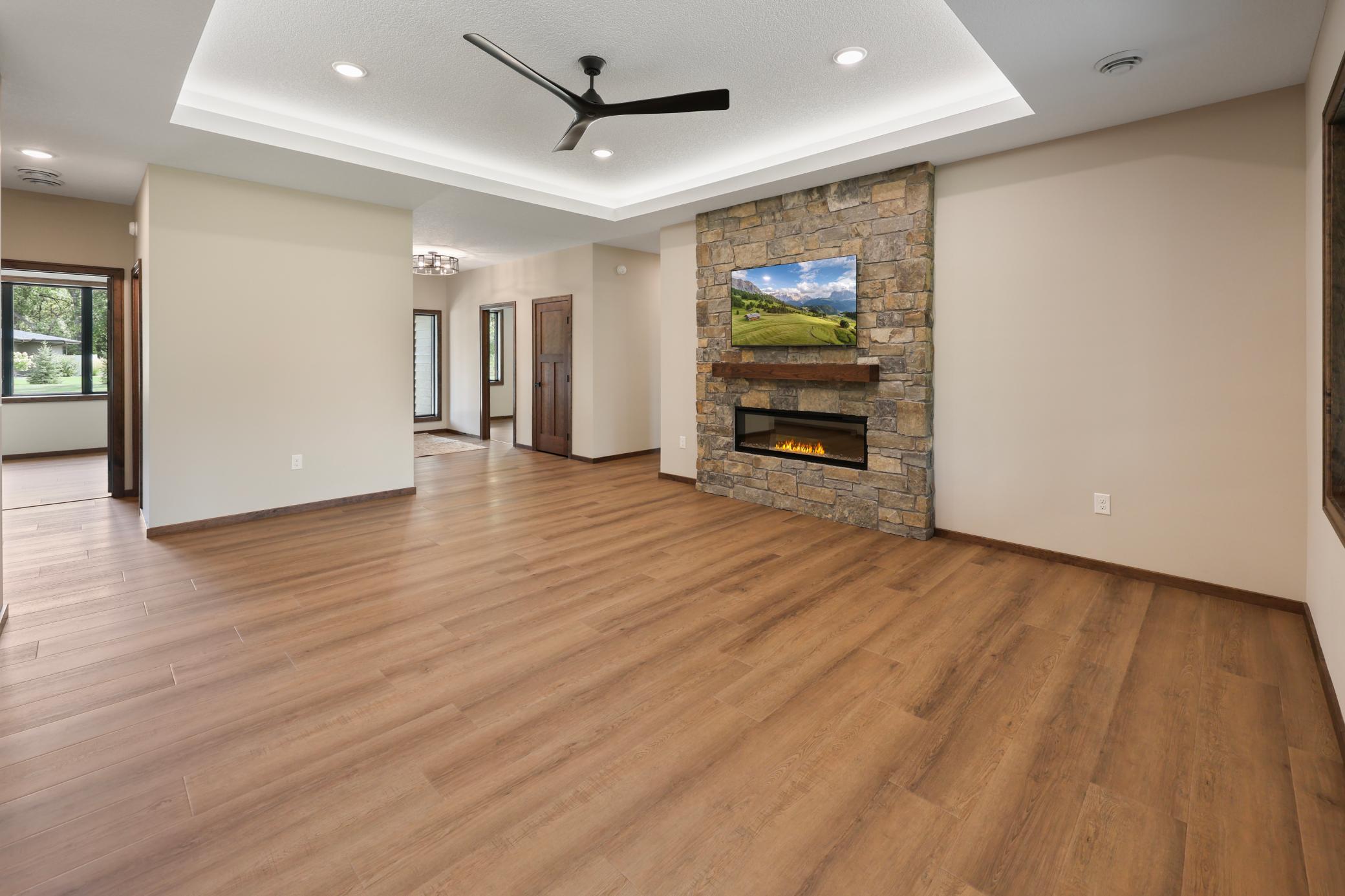 The family room offers a warm stone fireplace