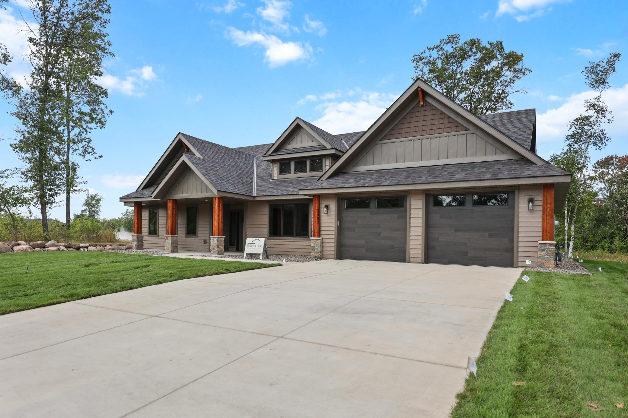 Concrete driveway leading to the 3 stall garage, 2 wide, with 3rd deep