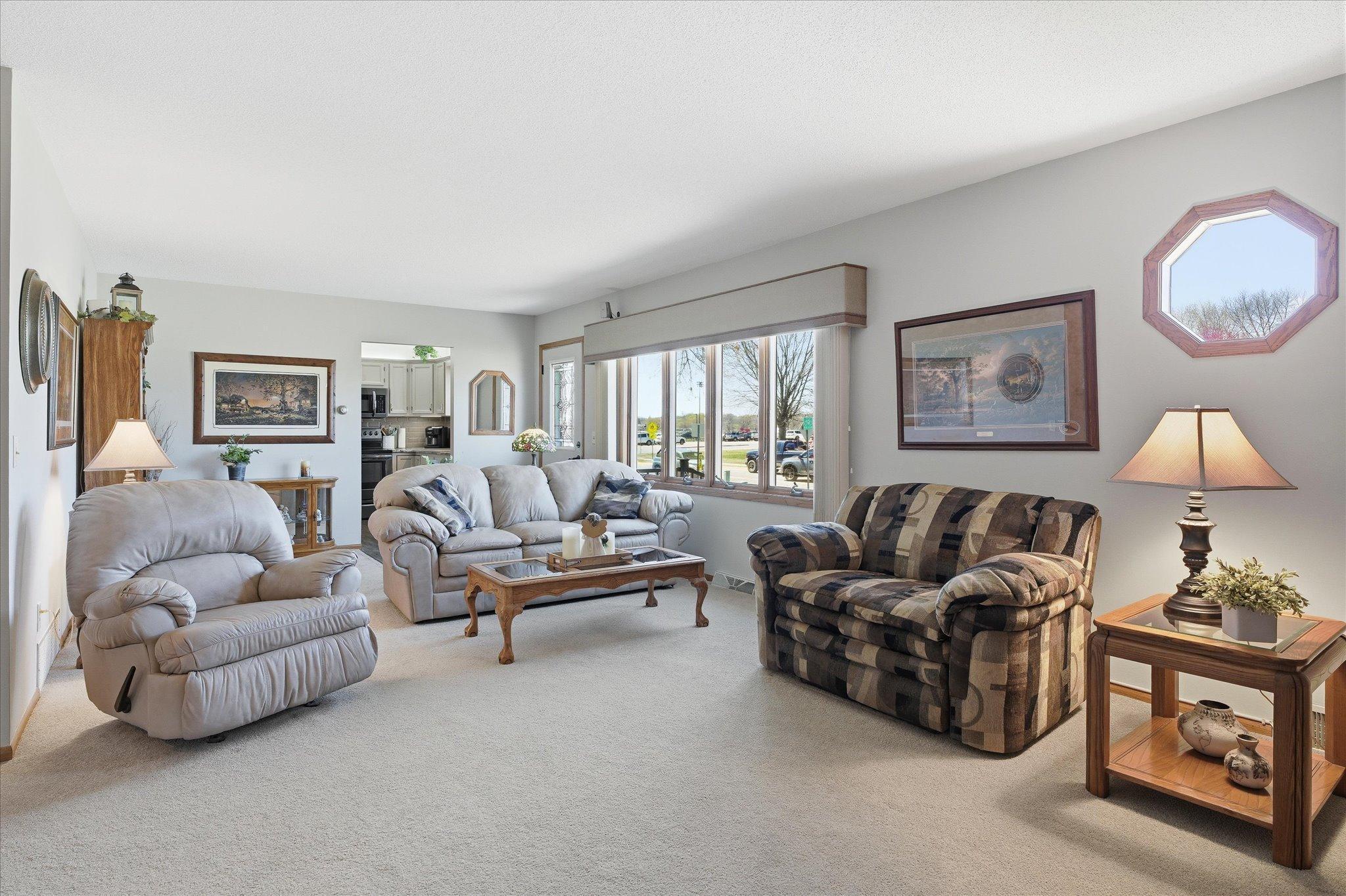 The main level living room is huge and perfect for gatherings and entertaining. Notice the large windows for plenty of sunlight.