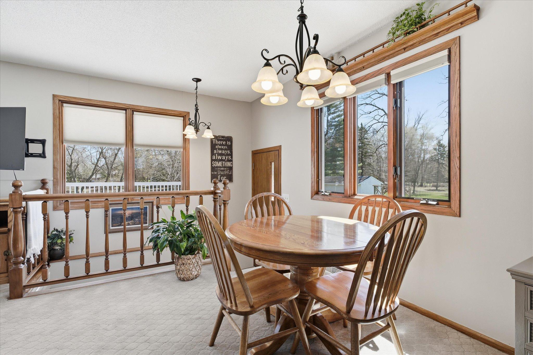 A view of the dining room area and steps leading down to the basement plus an additional entry to the home.