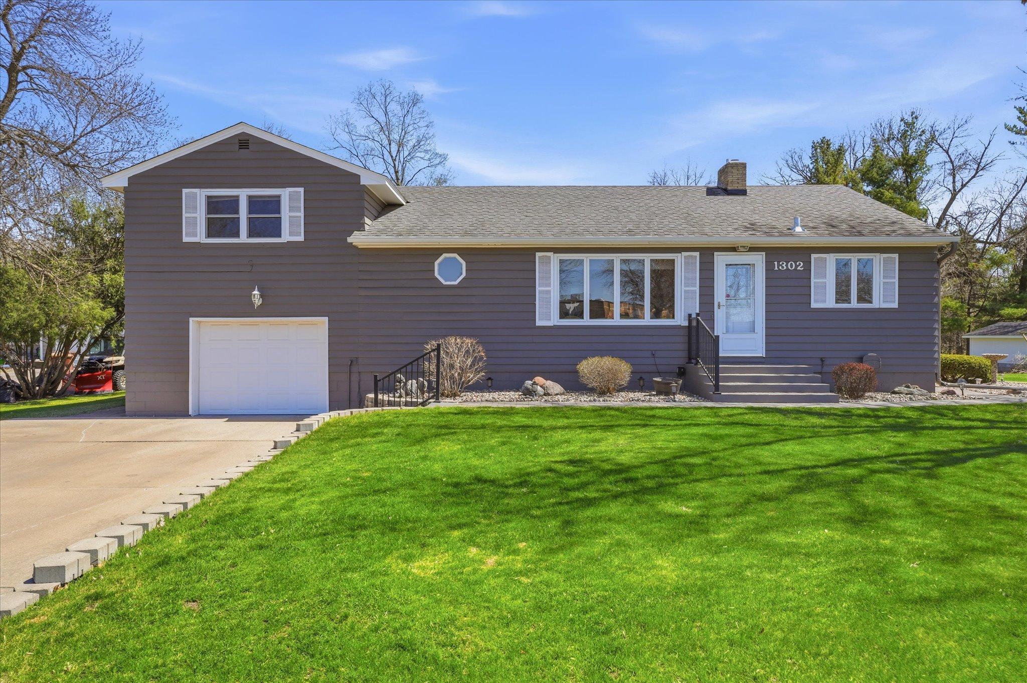 Fabulous landscaping and concrete driveway with extra parking space