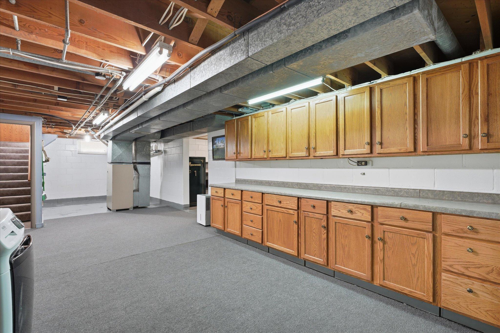 Walk down to the basement level and look at all this cabinetry and space for crafts, storage, workshop, so many options!