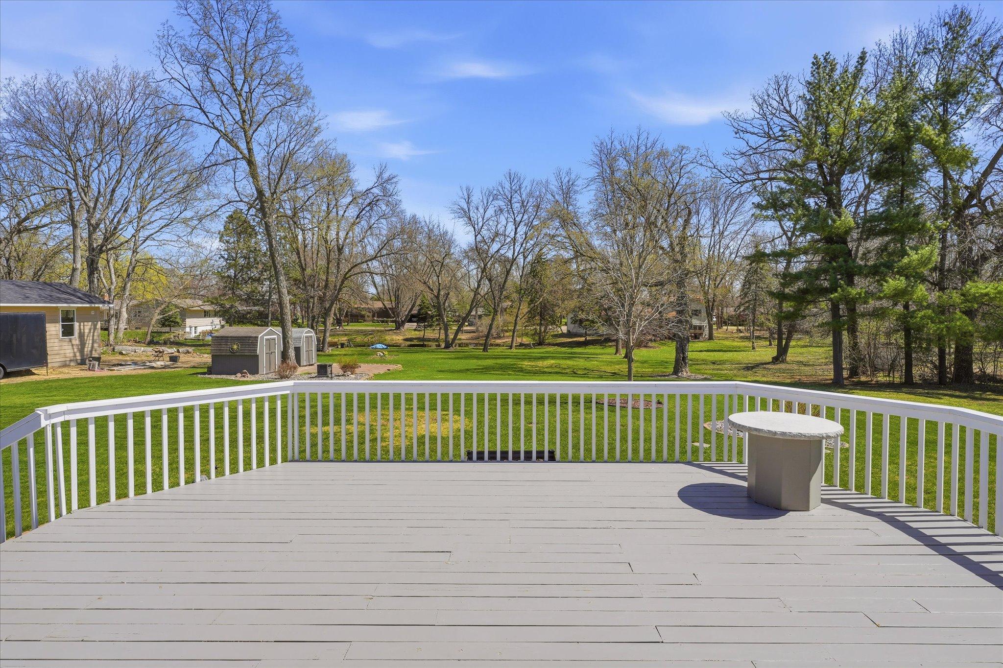 Look at this view of the massive backyard! The table on the deck stays with the home.