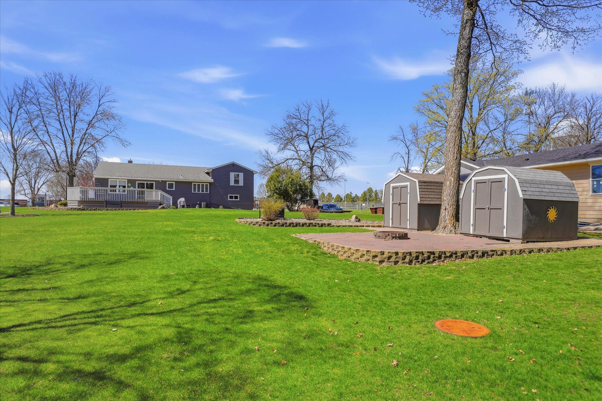 Rear view of the large backyard, sheds and home.