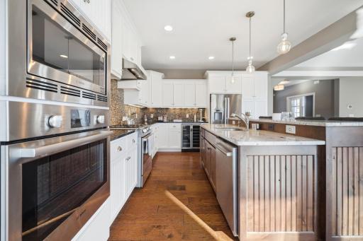 Large, very bright gourmet kitchen with stainless steel appliances, granite countertops, custom cabinetry