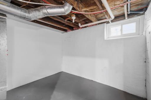 The utility room is clean and dry. To the left are the mechanicals, to the right is an additional storage room which has the new electrical panel.