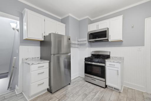 Additional counter space on either side of the fridge and oven.