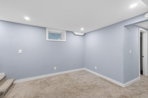 The lower level family room. The open door to the right is the unfinished bathroom.