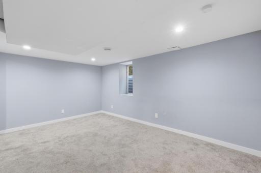 The generous lower level bedroom with recessed lighting and egress.