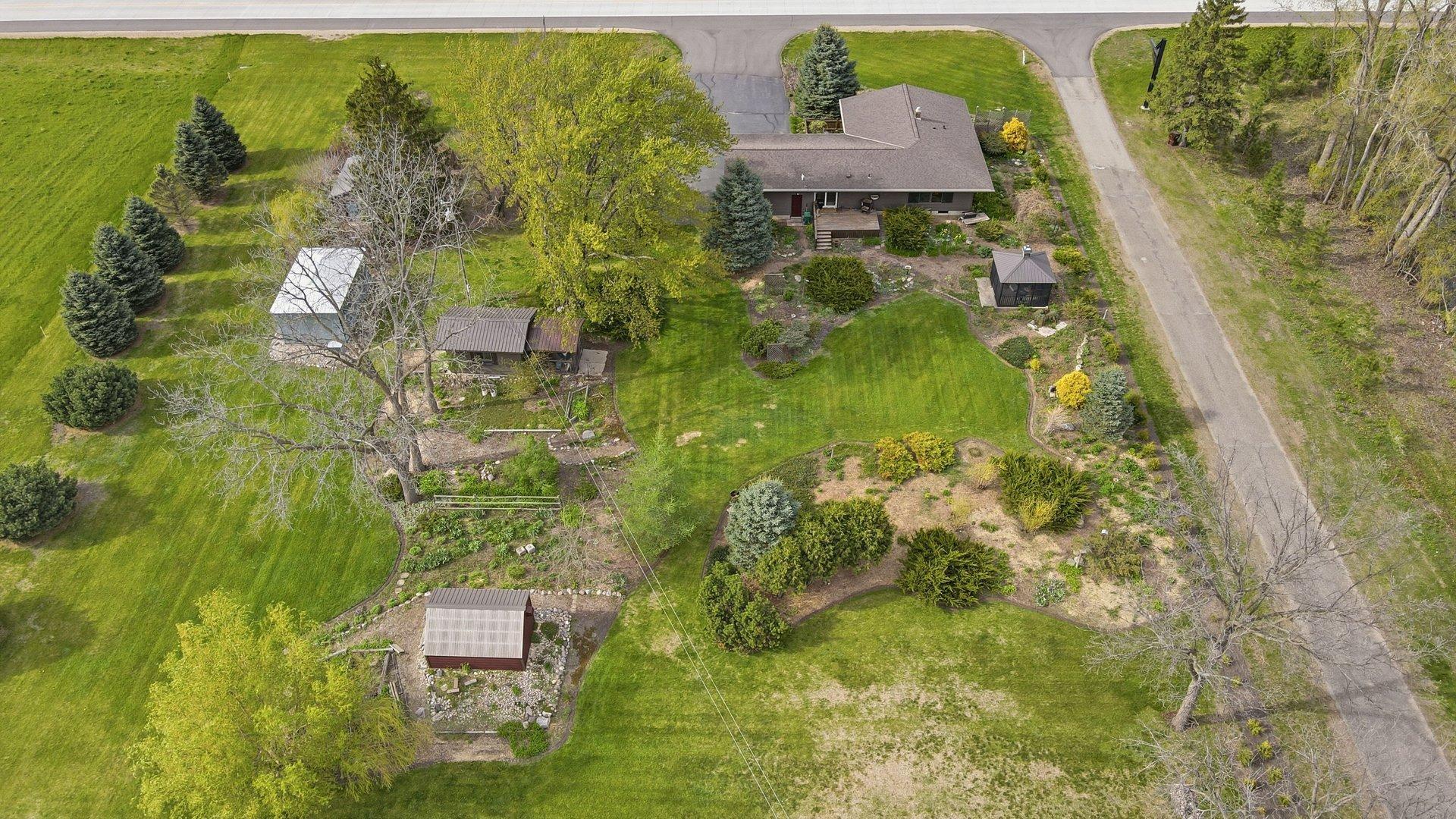 Great view of all the outbuildings including a She Shed and Walk in Cooler - possibilities are endless!