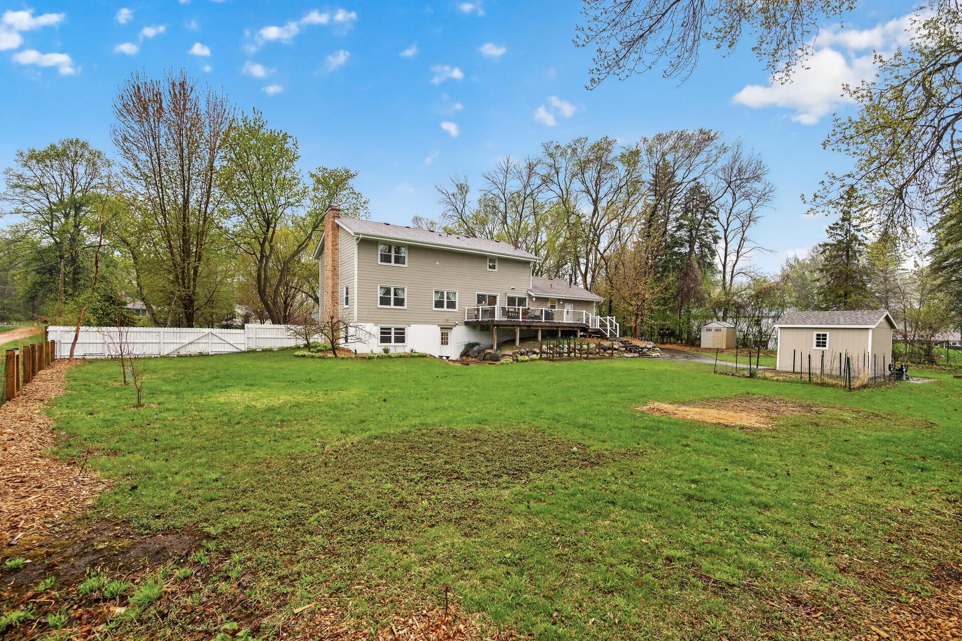 Nice fenced yard + 2 sheds for the toys.