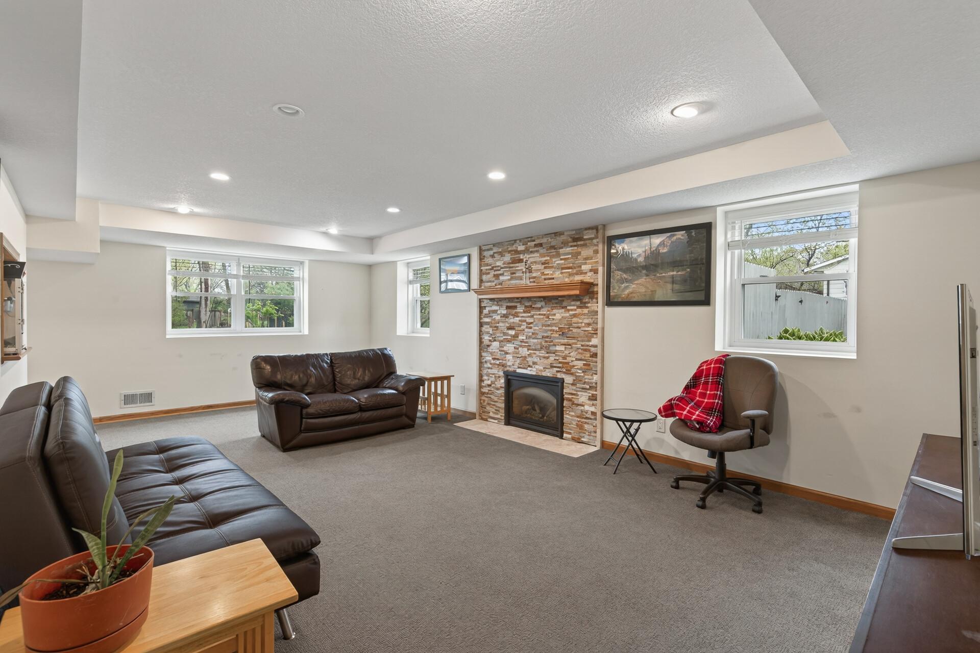 The lower level family room is another great hangout spot and the gas fireplace will keep you warm on those chilly nights.
