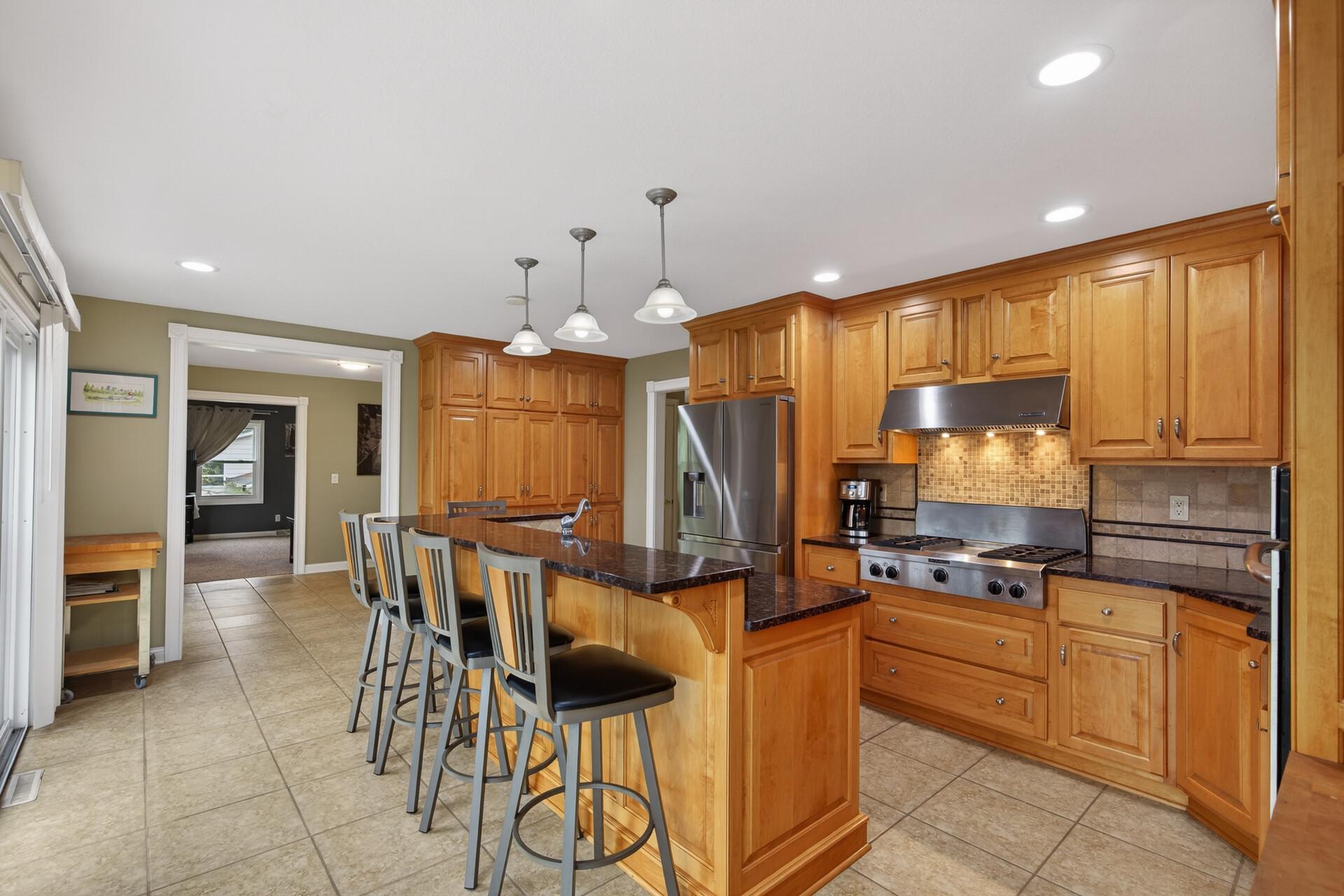 You'll love the chef style gas cooktop - bonus: the wall of cabinets is the perfect pantry.