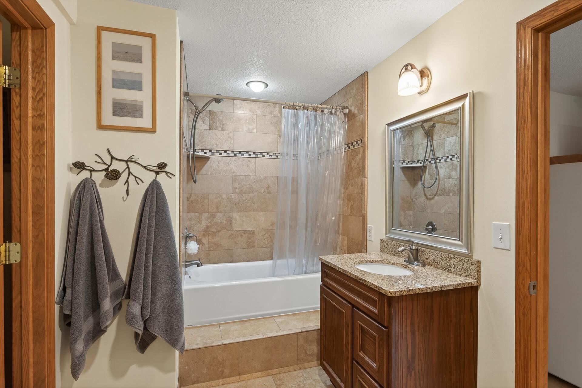 Great lower level full bathroom with nice tiled floors.