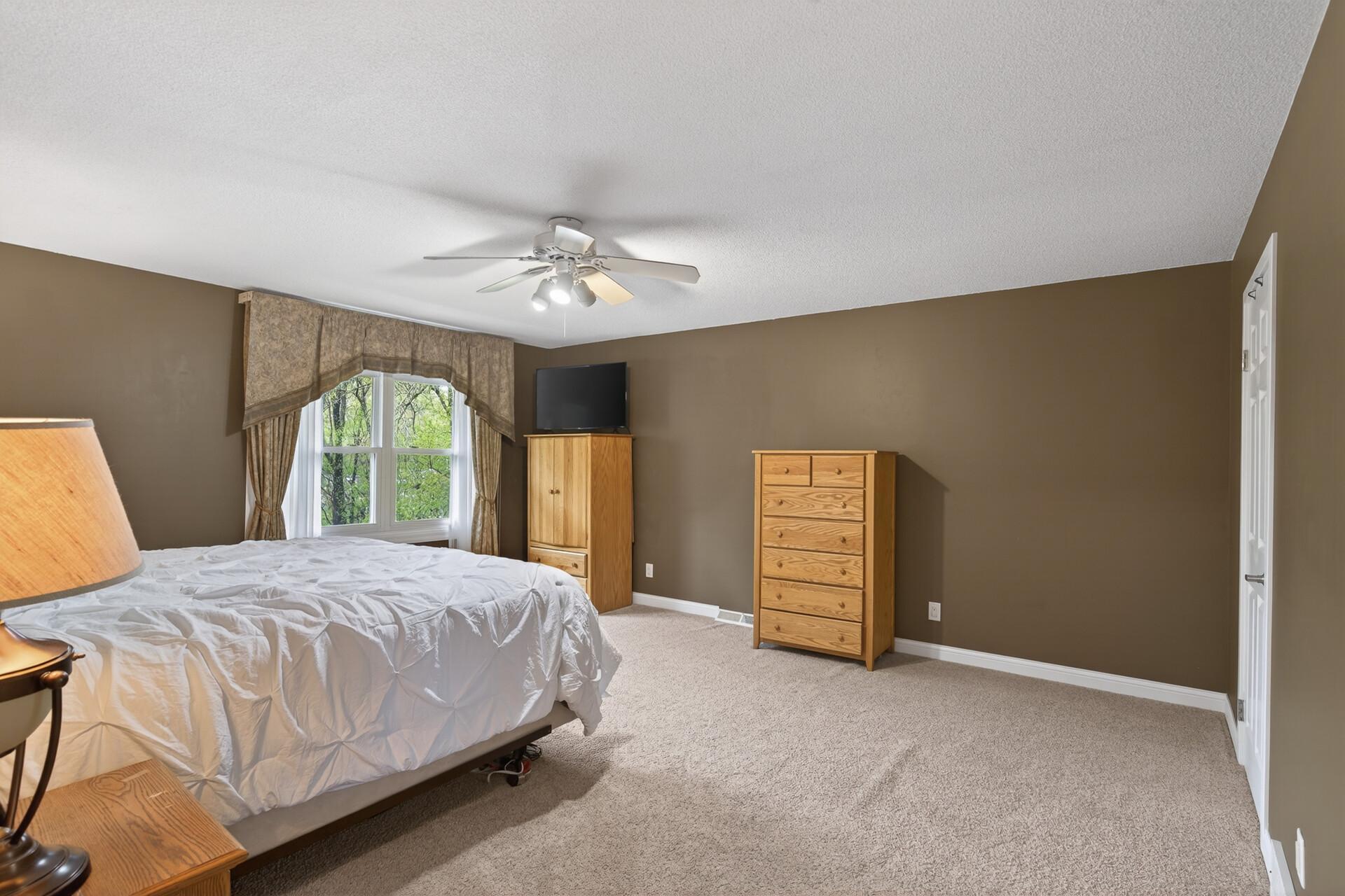Spacious Primary Bedroom w/ private ensuite bathroom & large walk-in closet.