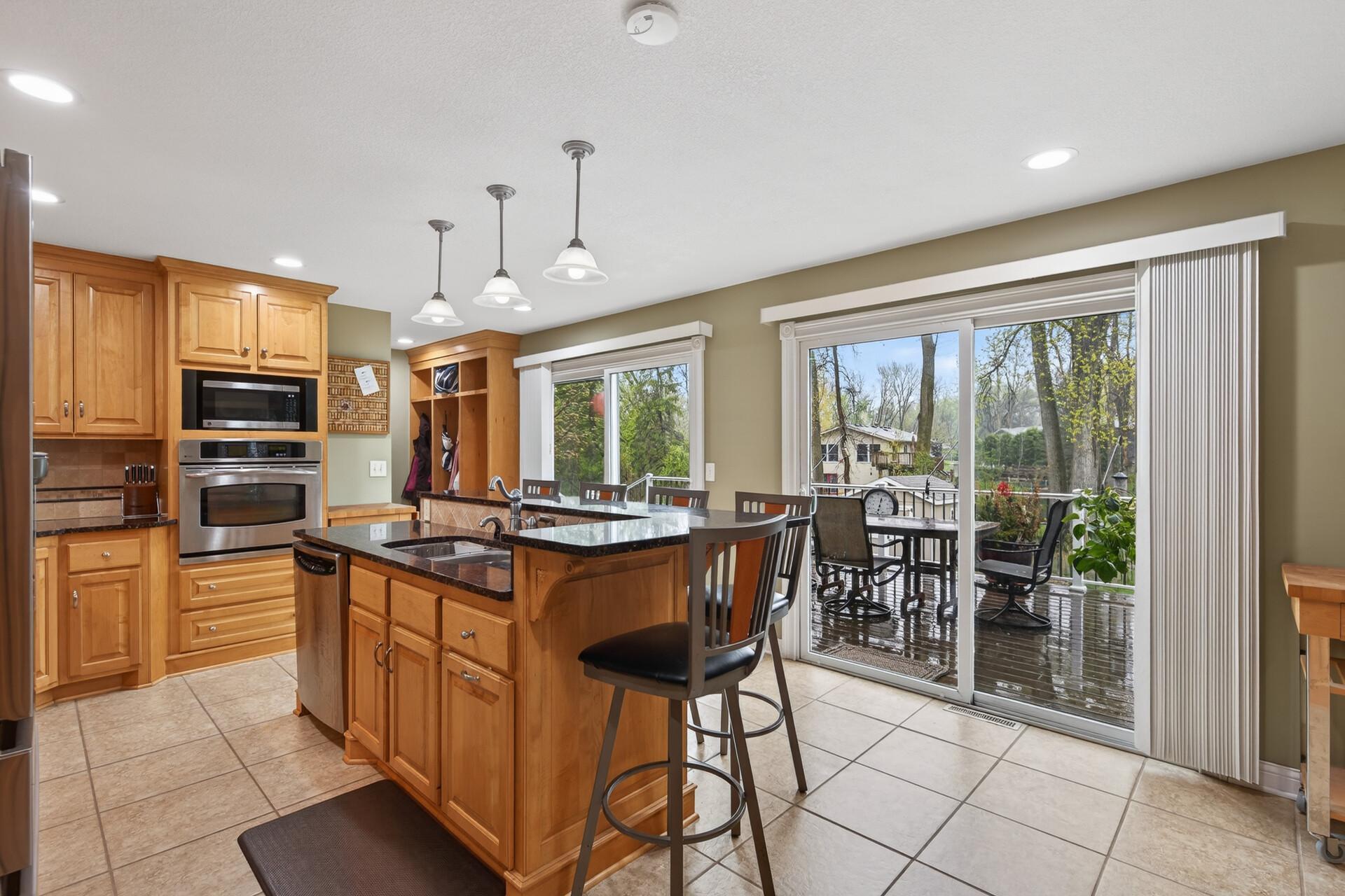 Updated kitchen w/ custom cabinets, granite countertops, tile backsplash & patio doors that bring you to you private oasis.