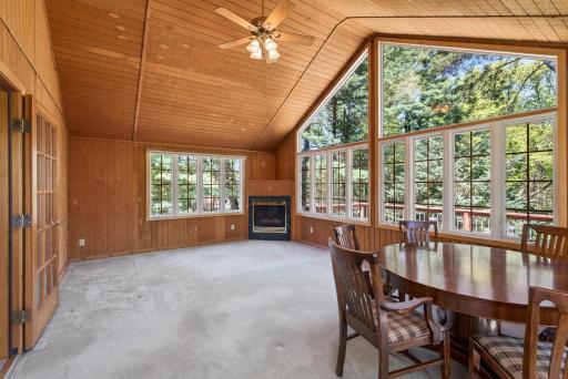 Spacious four season porch with gorgeous fireplace.