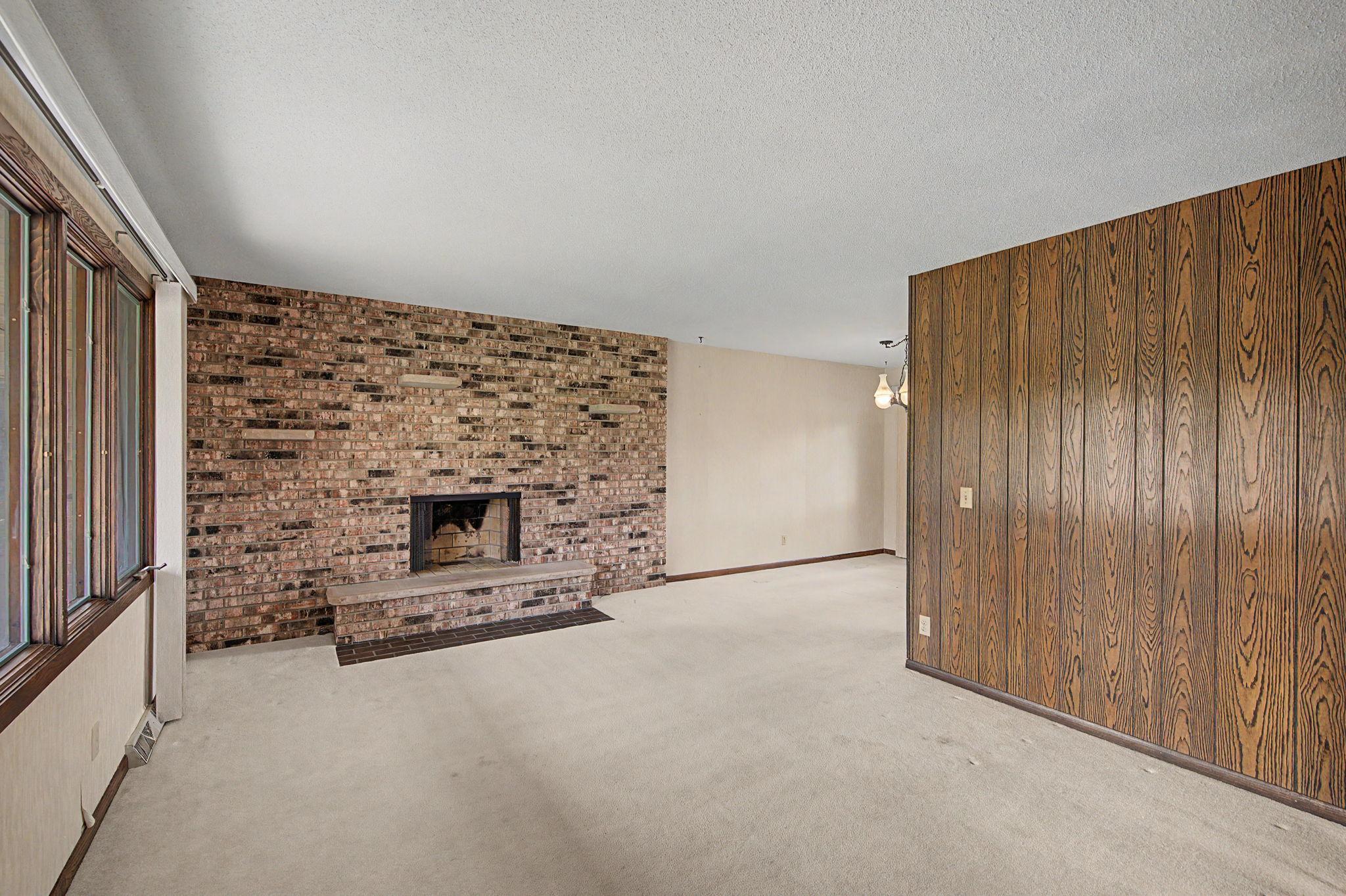 The living room has a floor to ceiling wood burning brick fireplace.The sellers did not use the fireplace and only used as decorative.
