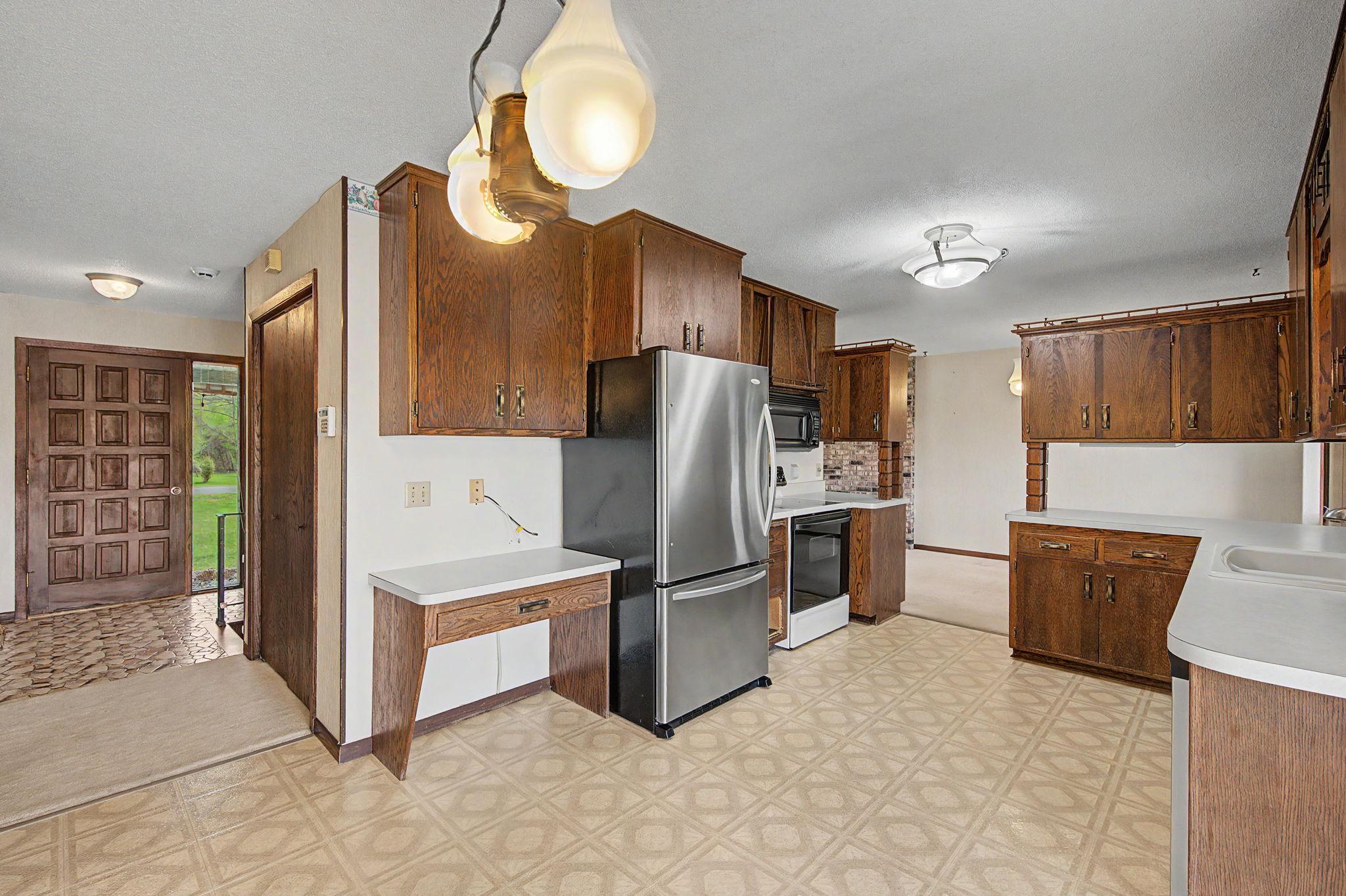 Another view of the kitchen with the hallway to the front door.