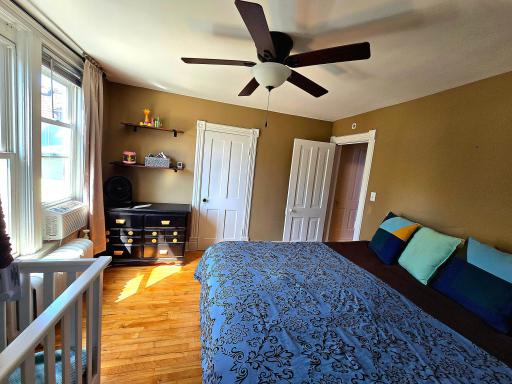 Primary bedroom with ceiling fan, original 4-panel doors, a deep closet, and A/C