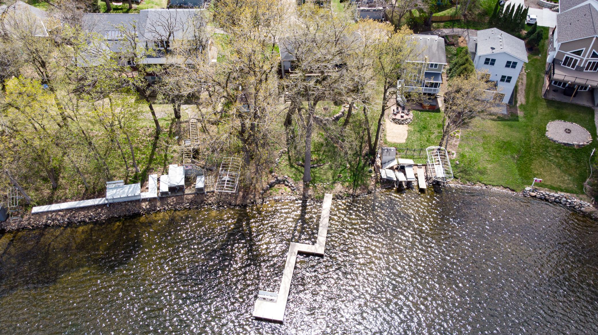 Enjoy GLORIOUS SUNSETS and panoramic views with nearly 80’ of NW-facing lakeshore on Spring Lake!