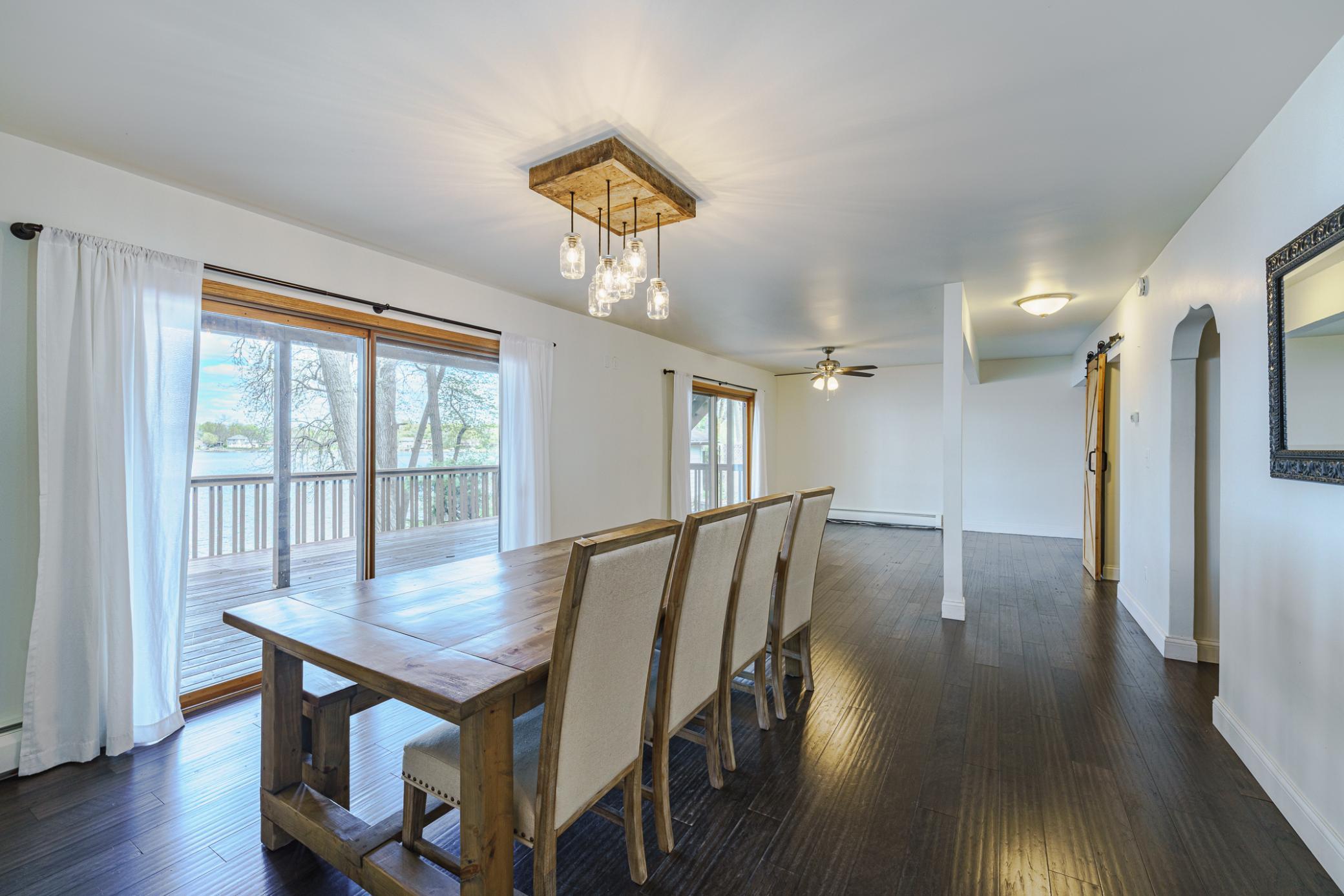 The dining room and family room are open and grand, with rich flooring, statement lighting, neutral paint and fantastic views!
