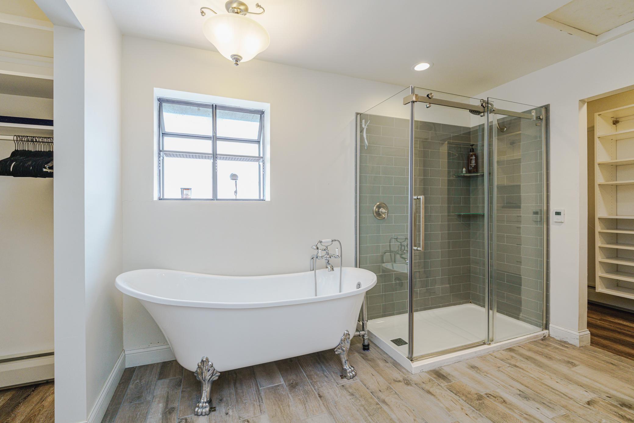 The attached primary bath also has a clawfoot tub and a walk-in tile shower!