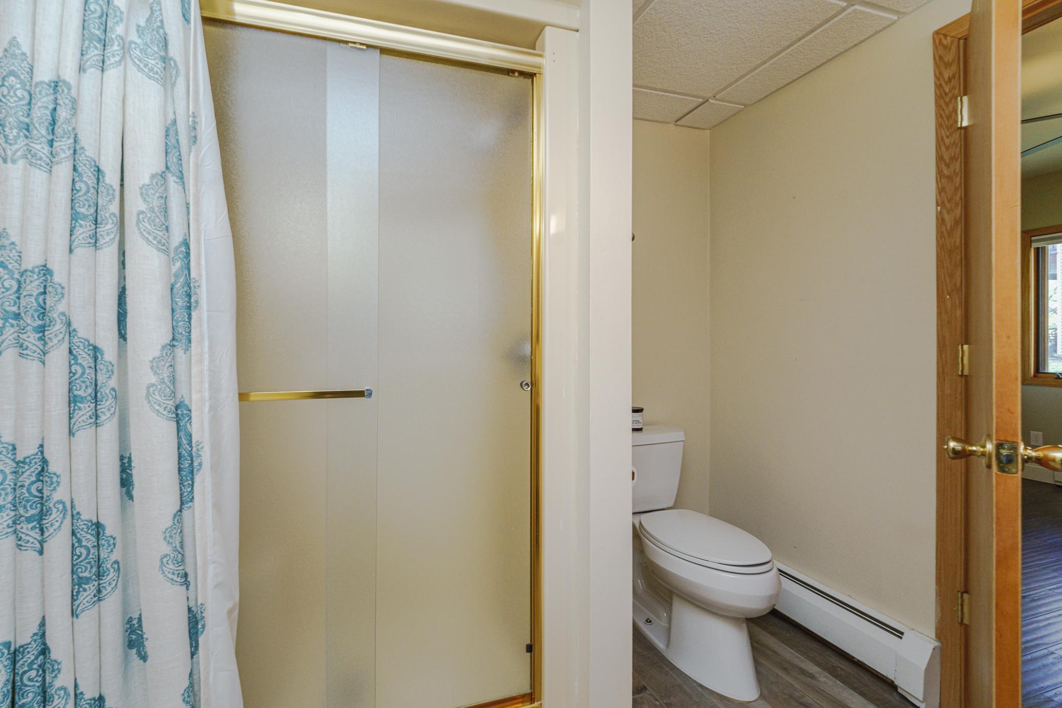 This 3/4 bathroom on the main floor lies between the foyer and the bedroom/office option.