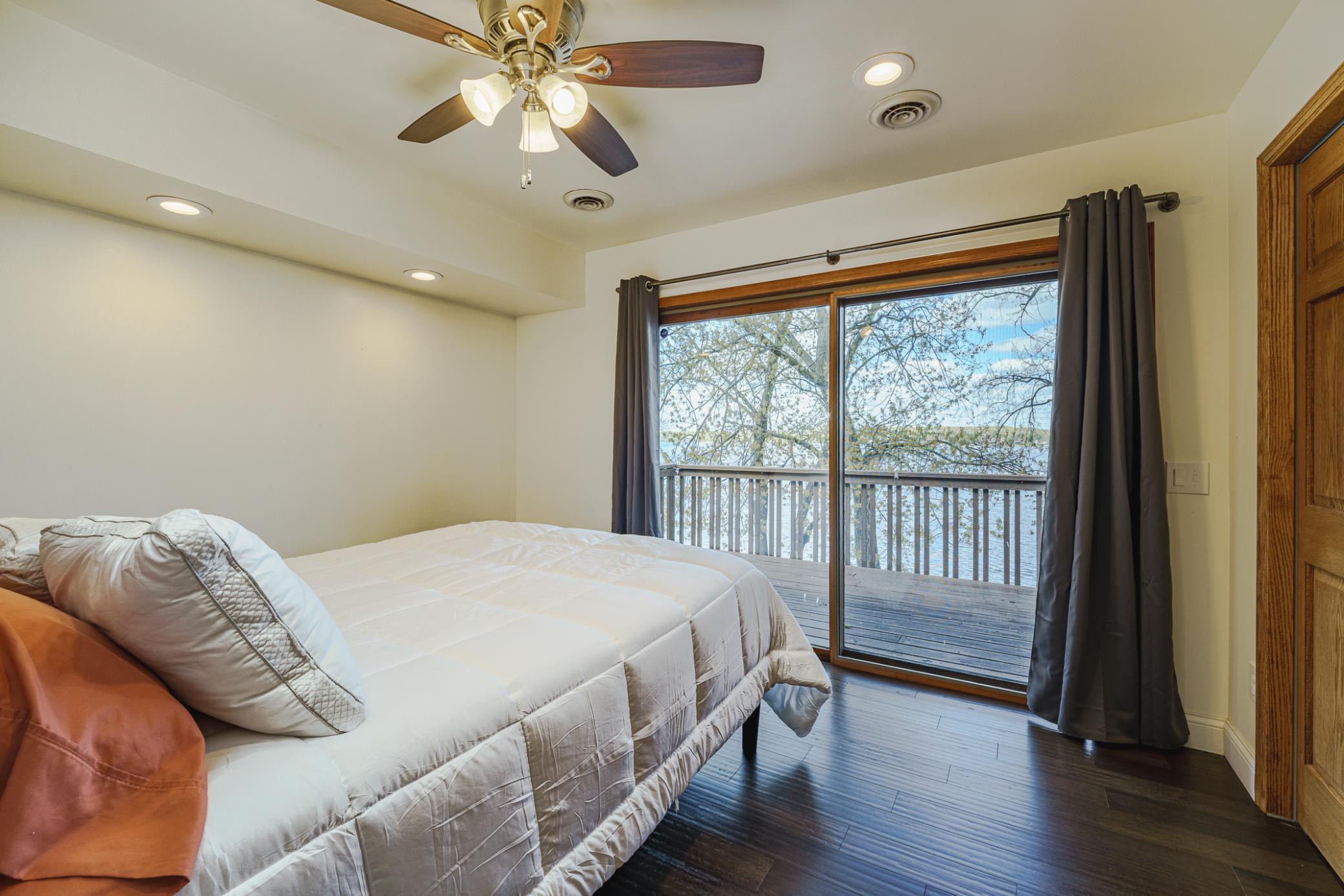 This is the fourth bedroom on the upper level. This room has beautiful flooring and a patio slider to the upper deck.