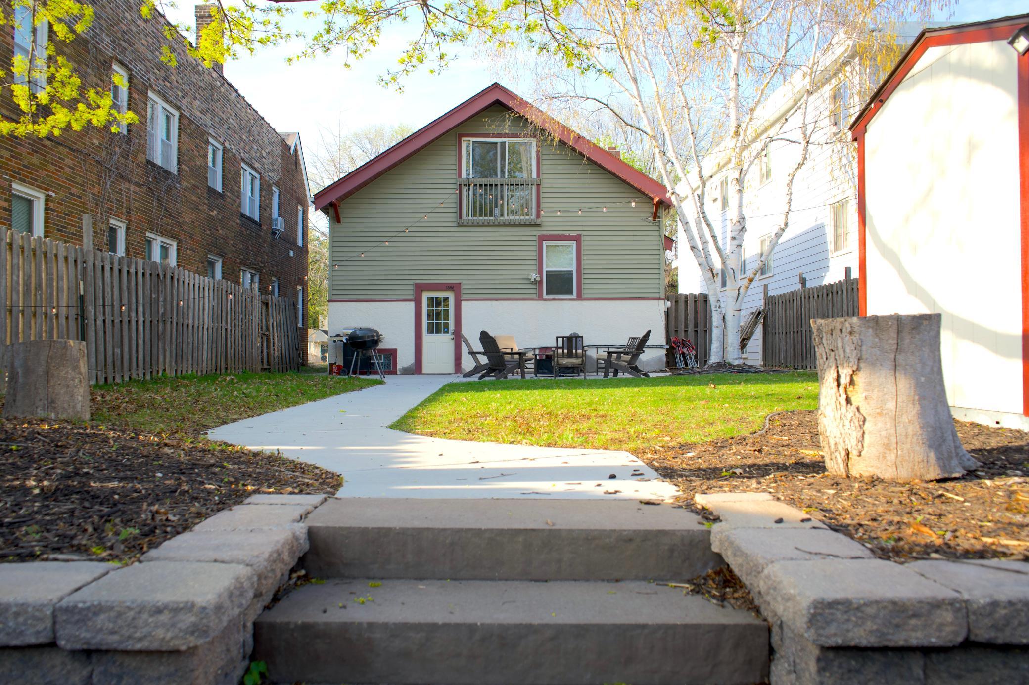 Private yard with new sidewalk, retaining wall and patio