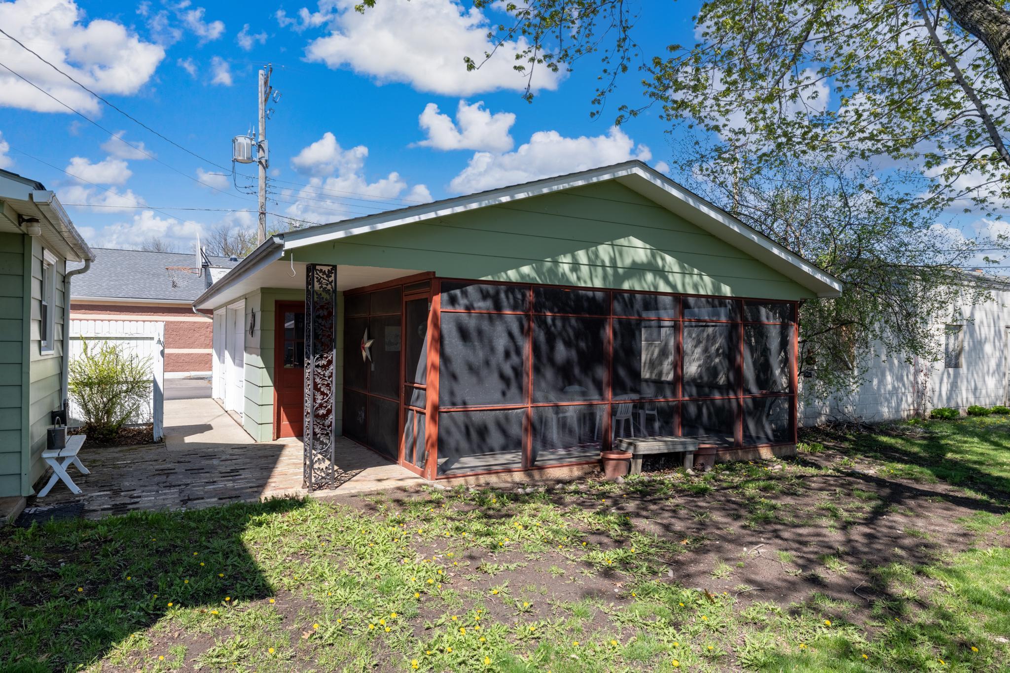 The 2-car garage features a large screened-in porch.