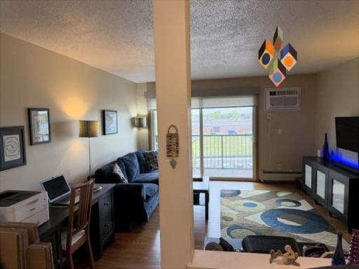 View of living area through wall opening from dining area.