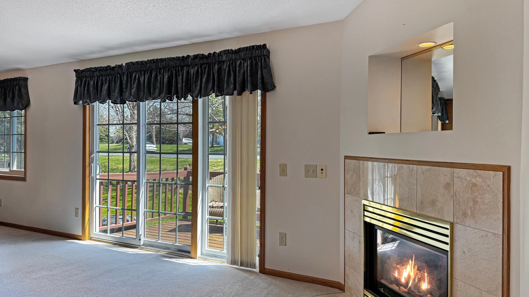Gas fireplace in the living room that overlooks the deck and backyard