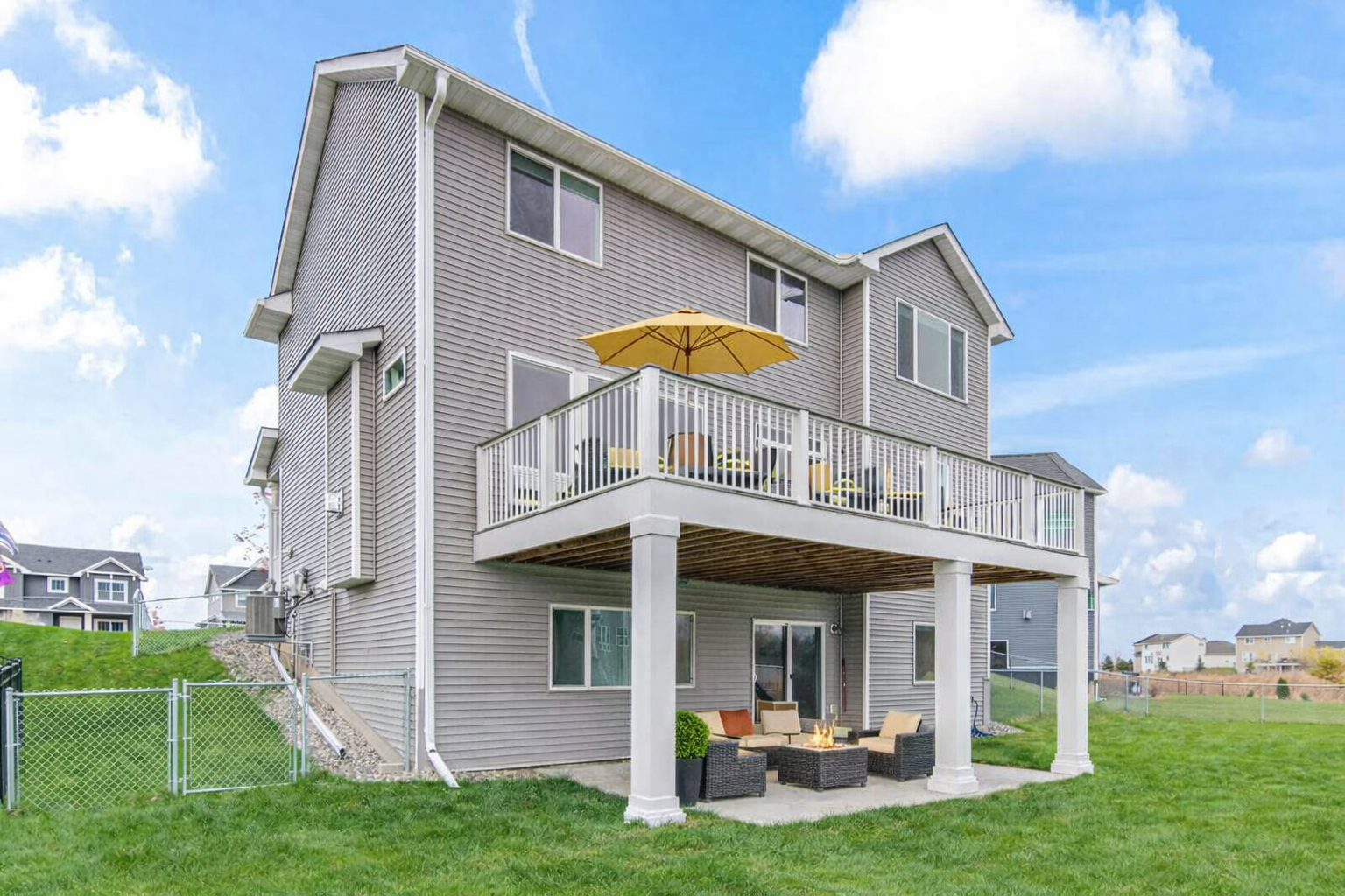Rear view. Patio/deck furniture is virtually staged.