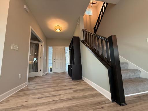 Main floor foyer with a built in shoe/coat rack.