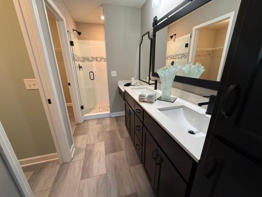 Owners bath features a separate toilet room with a pocket door, dual vanity, makeup table, a tiled walk in shower and walk in closet.