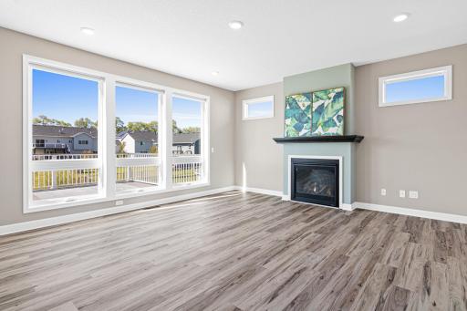 Brand new flooring on the main level replaced the carpet in the living room, creating a seamless flow and unifying the open concept living space. Floor to ceiling window allow natural light & a gas fireplace hihglights the space.