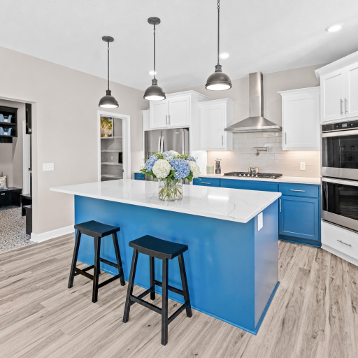 Quartz Counters, center island seating for up to 4, double ovens, pot filler above the stove, gas cooktop brand new flooring, abundant cabinetry, stylish lighting, huge pantry & soft gray backsplash perfectly