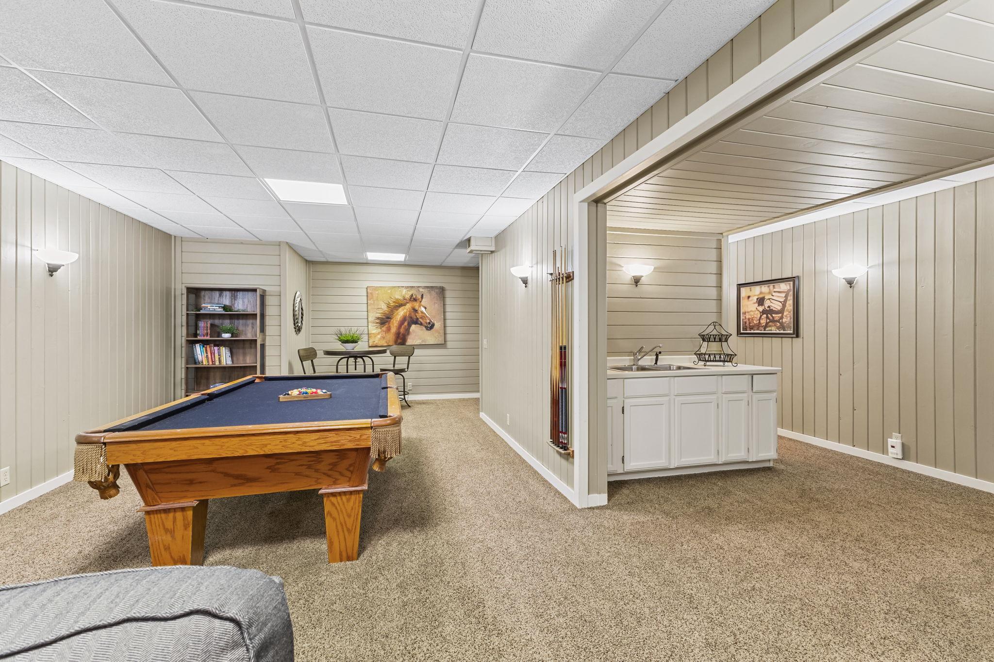 This expansive recreation room delivers an ideal entertaining room with a wet bar area for snacks and serving!