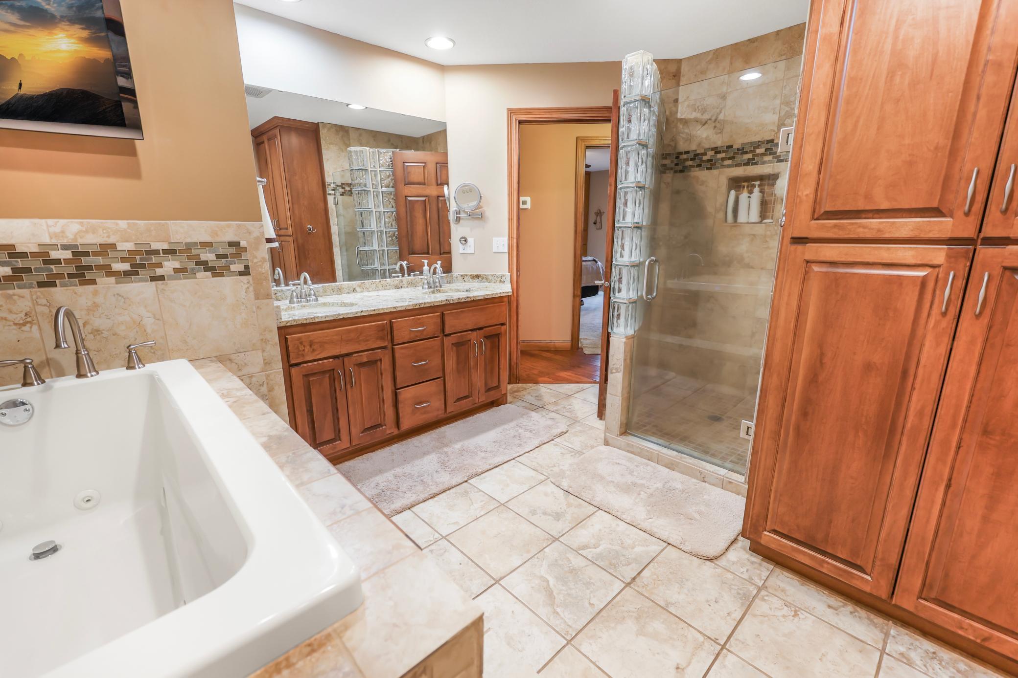 Double sink, tub, tiled shower